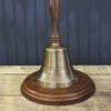 13 inch antiqued brass wood handled bell shown with optional walnut stained hardwood circular base.