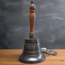  13 inch tall, 6 inch diameter brass and wood hand bell shown with dark bronze finish and three lines of optional text engraving