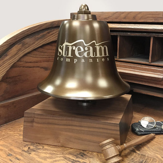 Large antiqued brass stock market bell with optional logo mounted on a deluxe walnut wood base with a wood mallet striker
