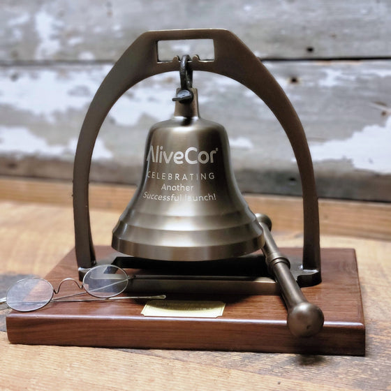 Antiqued finish solid brass 4 inch diameter desk bell on a wood base with striker and an optional logo engraving plus optional brass nameplate