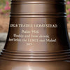 Closeup of five line text engraving featuring the Bible Psalm 95:6 on an antiqued finish  brass bell