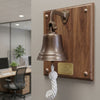 5 inch antiqued wall bell on wood plaque with brass nameplate in an office setting
