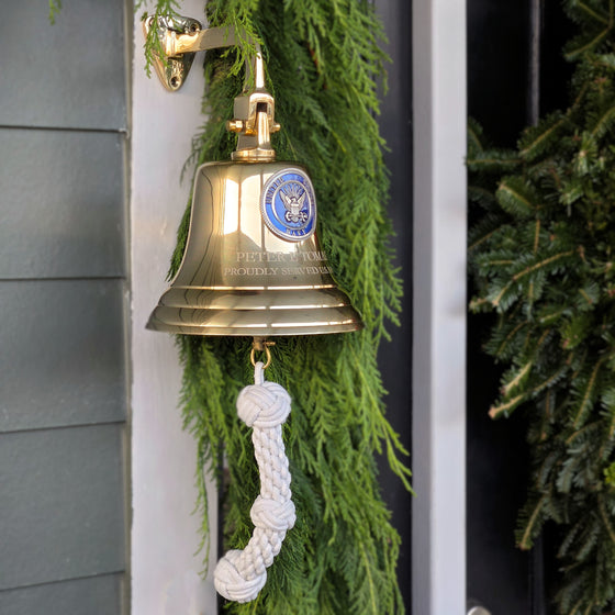 7 inch diameter polished brass wall bell with Navy emblem and two lines of engraving