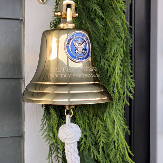 7 inch diameter polished brass wall bell with Navy emblem and two lines of engraving