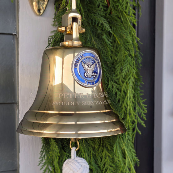 7 inch diameter polished brass wall bell with Navy emblem and two lines of engraving