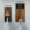 Size comparison of a 7 inch and an 8 inch diameter brass bell plaque