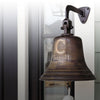 A dark bronze metal bell mounted on a black wall bracket, with the name 'Carroll' and 'Est. 2011' engraved on the front.