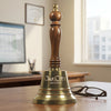 9 Inch Engravable Polished Brass Handbell with an AI generated background