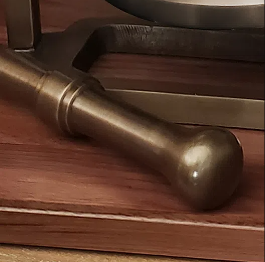 Closeup of solid brass antiqued finish striker for large brass desk bell