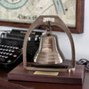 Antiqued brass bell with arch mounted on deluxe walnut base with company logos engraved on it