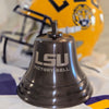 LSU Victory Bell with a football helmet in the background