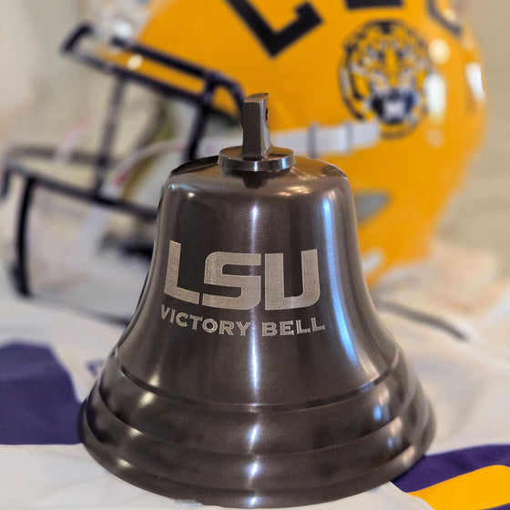 LSU Victory Bell with a football helmet in the background