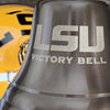 LSU Victory Bell with a yellow football helmet in the background