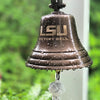 LSU Victory Bell with water droplets against a blurred green background