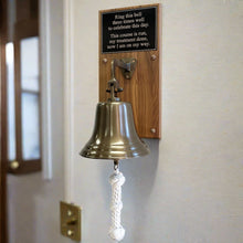  Wood plaque with engraved black plate on top and 8 inch antiqued brass bell with rope mounted on bottom