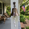 Antiqued brass wall bell hung on porch column with family tree and name engraved on it
