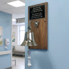 Bell on a wooden plaque with a  end of treatment message in a medical setting
