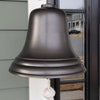 Closeup of a dark bronze finish 10 inch wall bell with no engraving hanging on side of front house door