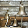 Three antiqued brass wall bells with text showing comparative sizes of 7 inch, 8 inch and 10 inch diameter bells