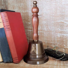  Antiqued Brass  hand bell with contoured hardwood handle and cancer ribbon engraved in contrasting gold on the face, with books and antique glasses