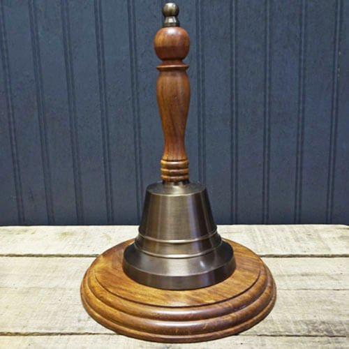 11 inch tall antiqued brass hand bell with optional walnut stained circular hardwood base
