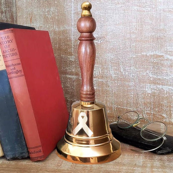 11 inch tall brass cancer hand bell shown in polished finish with engraved cancer ribbon