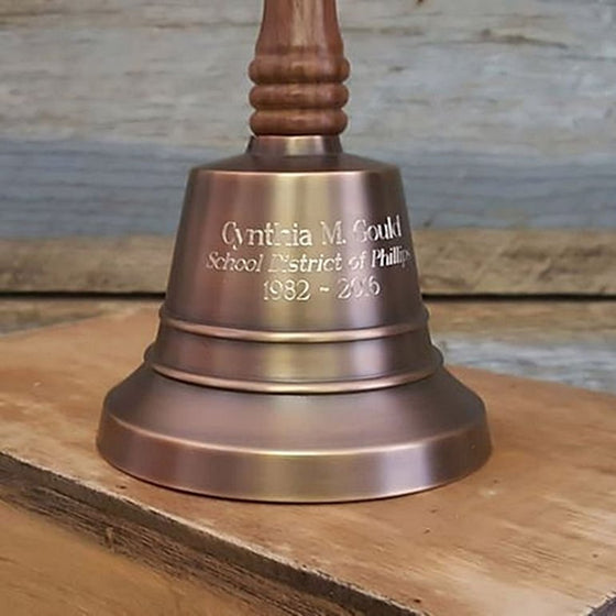 Closeup of antiqued brass 11 inch hand bell showing optional engraving