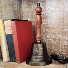  11 inch tall antiqued brass hand bell with contoured hardwood handle shown with 3 lines of customer chosen engraving
