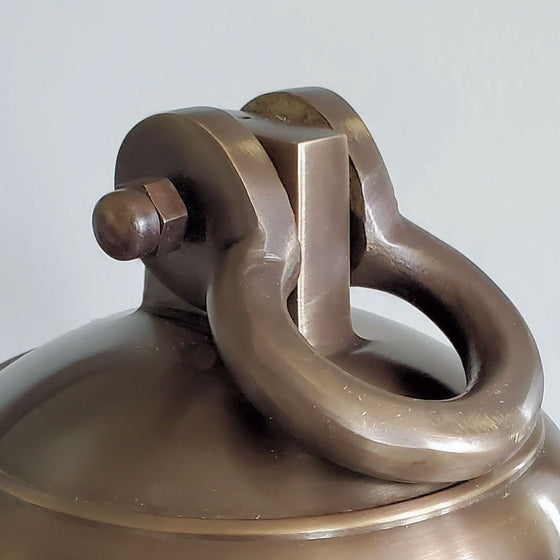 Closeup of a solid brass bell shackle attachment in antiqued brass finish
