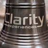 Closeup of side of 12 inch antiqued finish brass ridged wall bell showing sample logo engraving of Clarity experiences