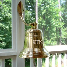  12 inch diameter polished finish wall bell shown on brass wall mount on back porch with last name engraved on surface