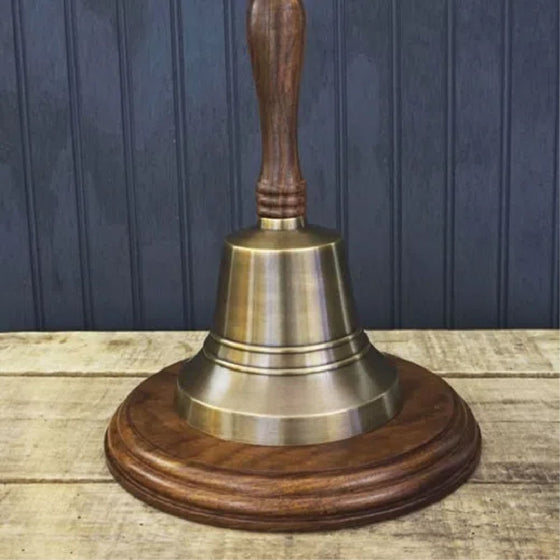 13 inch antiqued brass wood handled bell shown with optional walnut stained hardwood circular base.