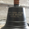 Closeup of customer engraving on the side of a dark bronze finish brass hand bell 