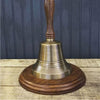 Hand bell shown displayed on an optional walnut stained circular wood base