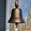 Closeup of 14 inch distressed finish antiqued brass bell with shackle in an outside setting