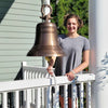 18 inch ridged antiqued solid brass bell and shackle attachment shown with young lady for size reference