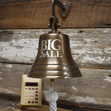  7 inch antiqued brass wall bell with engraved graphic Big $ale and older calculator