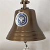 Closeup of silver and blue pewter medallion on the front of a 7 inch antiqued finish brass wall bell