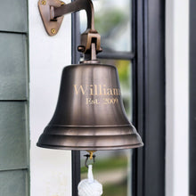  Closeup of 7 inch engraved antique finish brass wall bell with two lines of personalized engraving