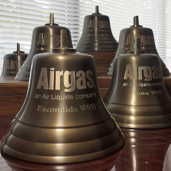 Example of a company logo engraved on several 7 inch diameter antiqued bells