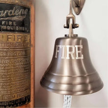  7 inch antiqued finish solid brass wall bell with word FIRE engraved in large capital letters across the front and a brass antique fire extinguisher