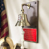 7 inch diameter polished gold finish solid brass wall bell with silver and red Maltese Cross firefighter pewter medallion mounted on a walnut wood wall plaque and a large red and gold plate custom engraved