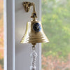 7 inch diameter polished gold finish solid brass bell with silver and blue large Navy logo medallion mounted on outside porch wall
