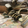 Closeup of 8 inch antiqued brass sextant on vintage map