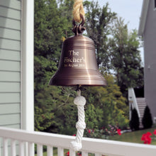  Eight inch diameter antiqued brass finish wall bell with shackle and three lines of personalized engraving hanging from rope outside 