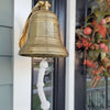 8 inch diameter polished finish solid brass ridged wall bell mounted near front door with three lines of personal engraving