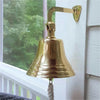 8 inch polished finish solid brass wall & ship bell with no engraving mounted on outside porch wall