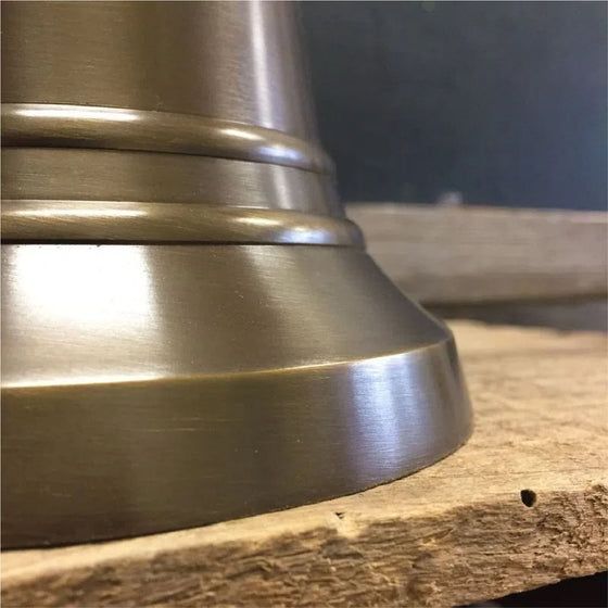Closeup of ridges on nine inch tall antiqued brass hand bell
