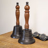 9 inch tall bronze finish brass and wood hand bell with three lines of engraving shown