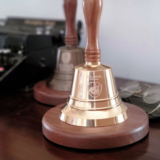 9 inch tall polished finish brass and wood hand bell shown with optional logo engraving and optional deluxe round wood base